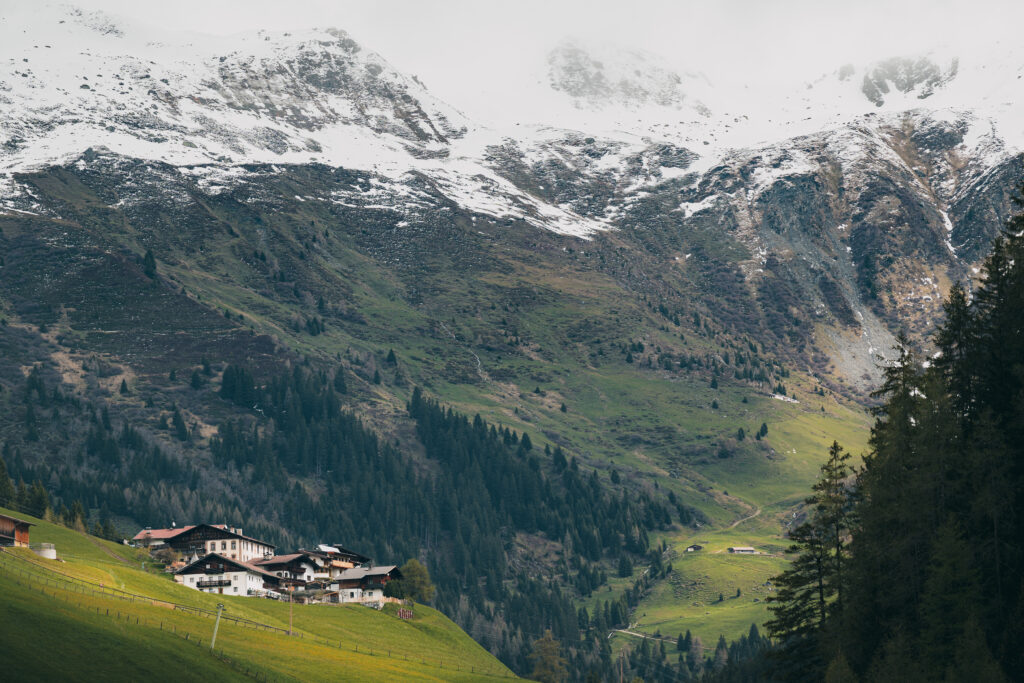 Im Navistal treffen grüne Wiesen auf verschneite Berge