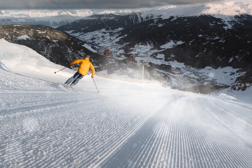 Frühaufsteher genießen frisch präparierte Pisten und die besondere Stimmung des Sonnenaufgangs am Berg.